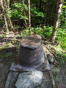 Latrine with rock.